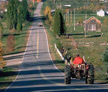 Tractor on Covey Hill Road along the Apple Route of the Chateauguay Valley along the US border in the Chateauguay Valley